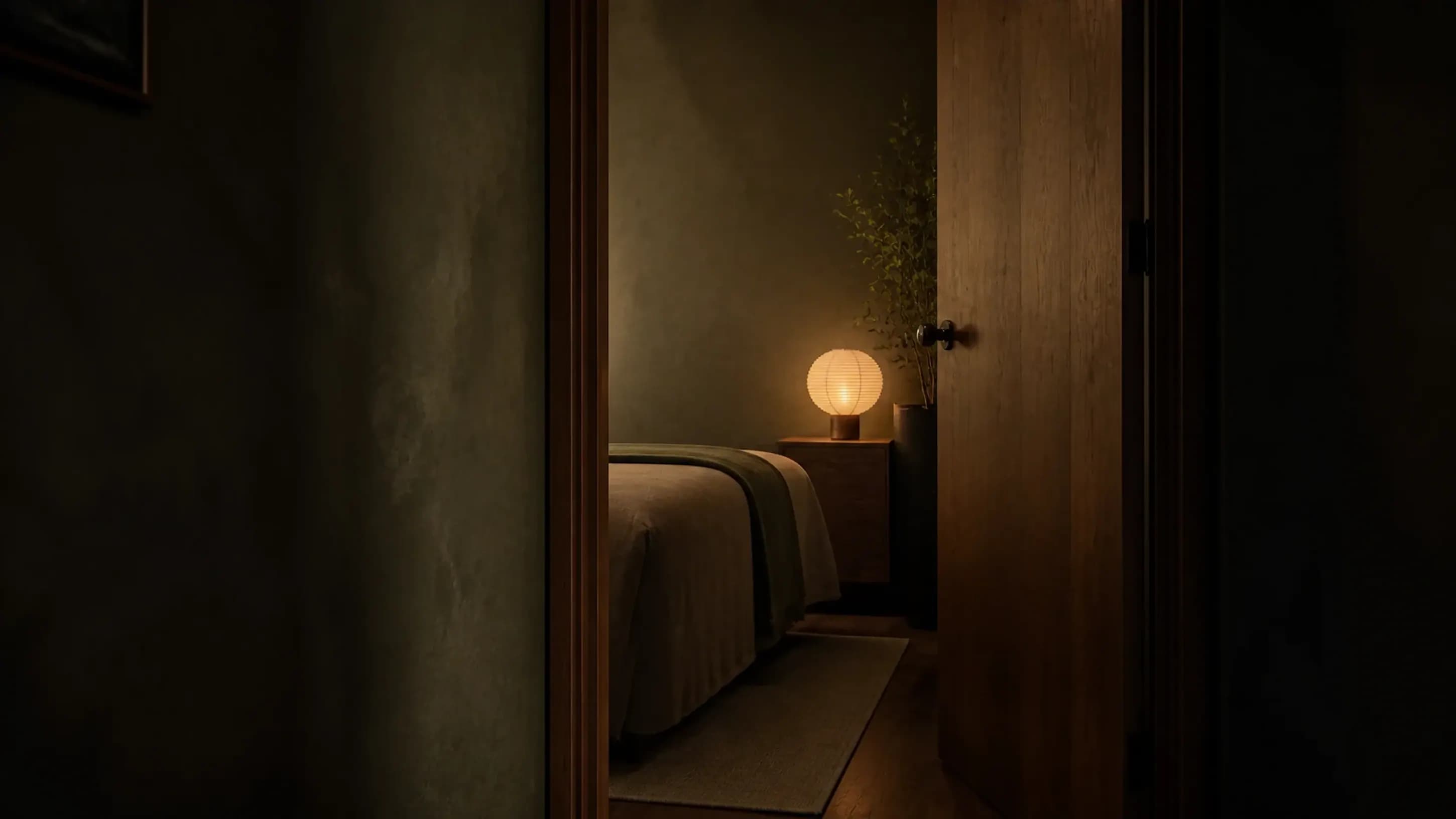 Concept image looking through a timber doorway into a softly lit private wellness room